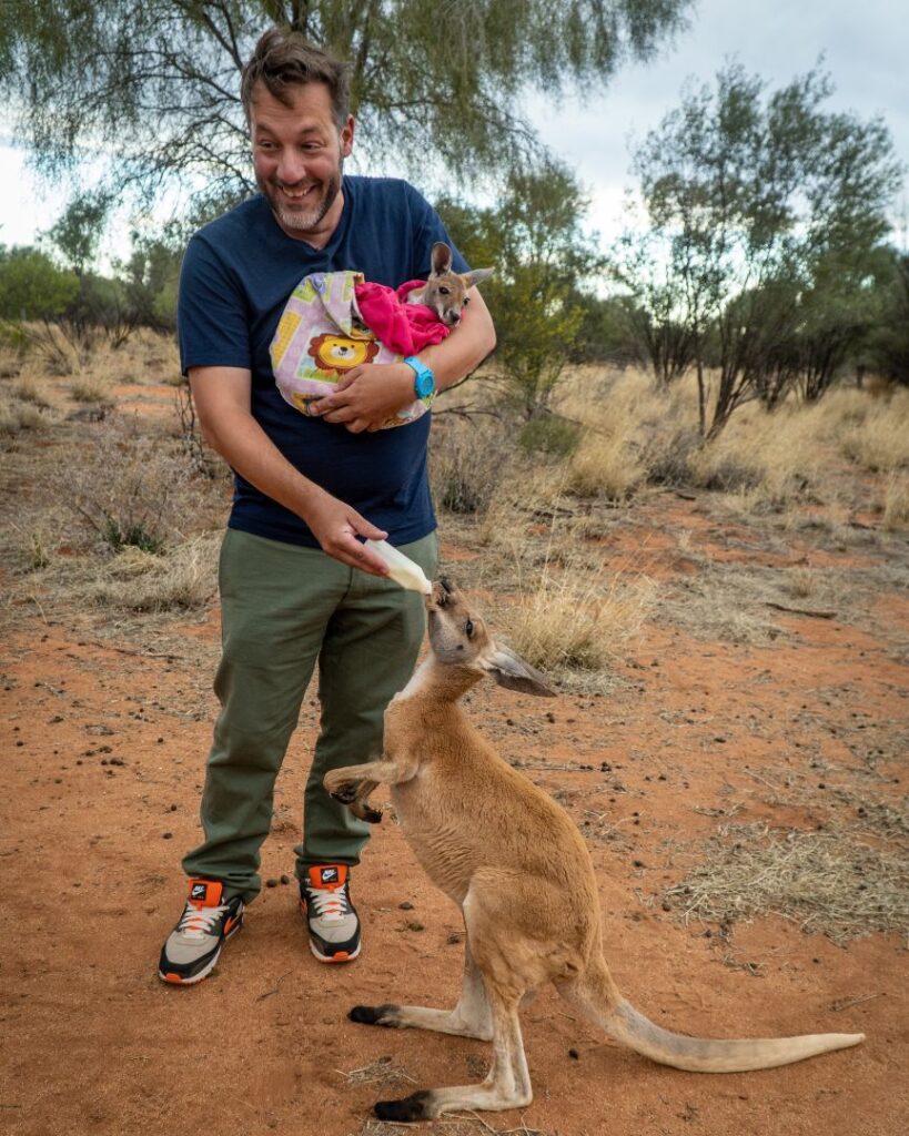 Jonathan Thompson in Australia holding a baby kangaroo